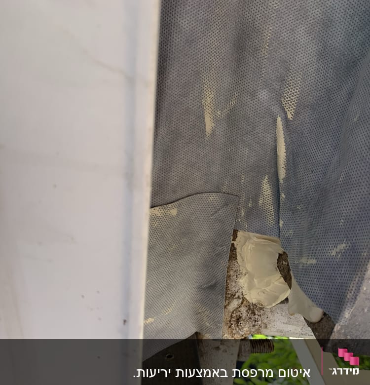 חומר איטום לבן על משטח מתכת אפור